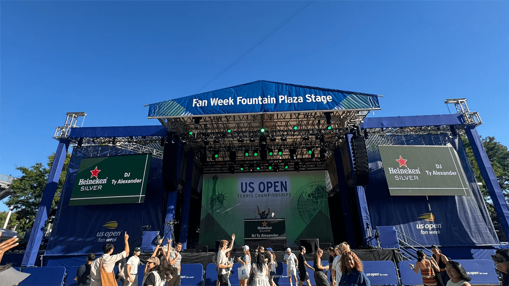 US Open Fan Week stage outside with people dancing in front of it