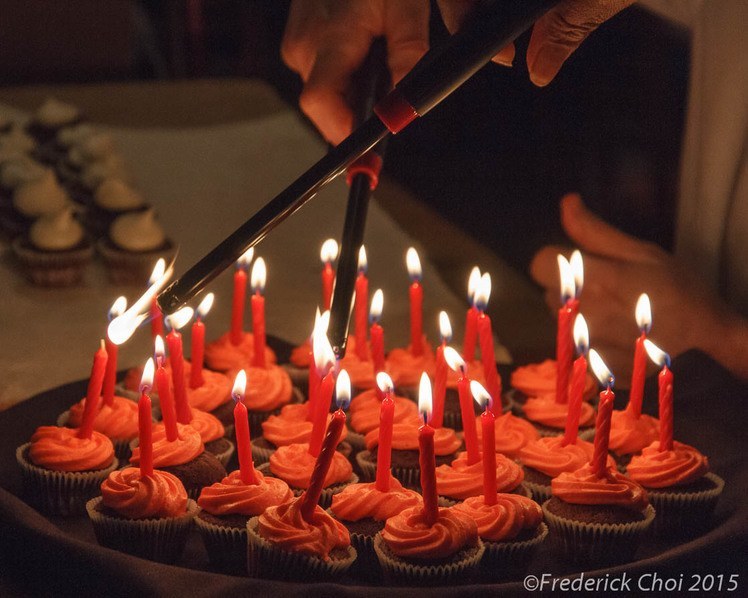 Lighting candles on cupcakes