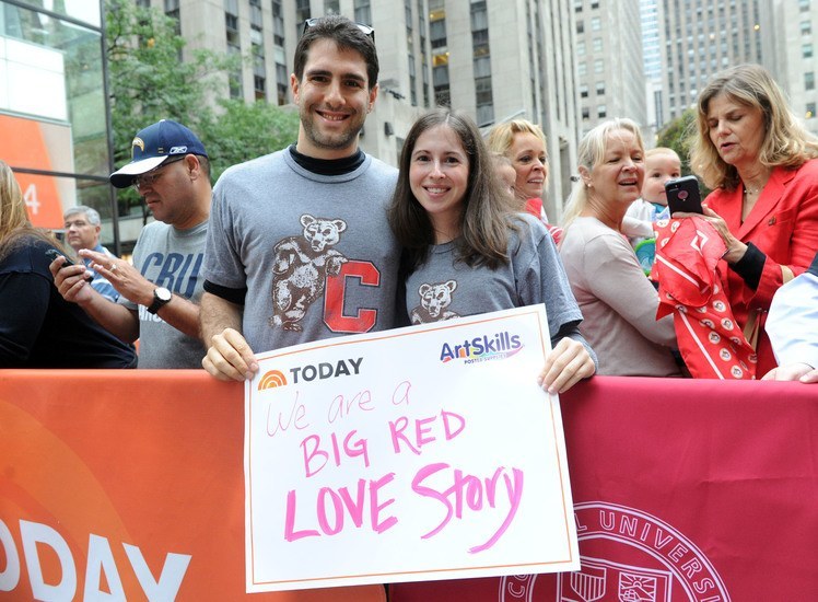 Cornellians hold sign that says We Are a Big Red Love Story