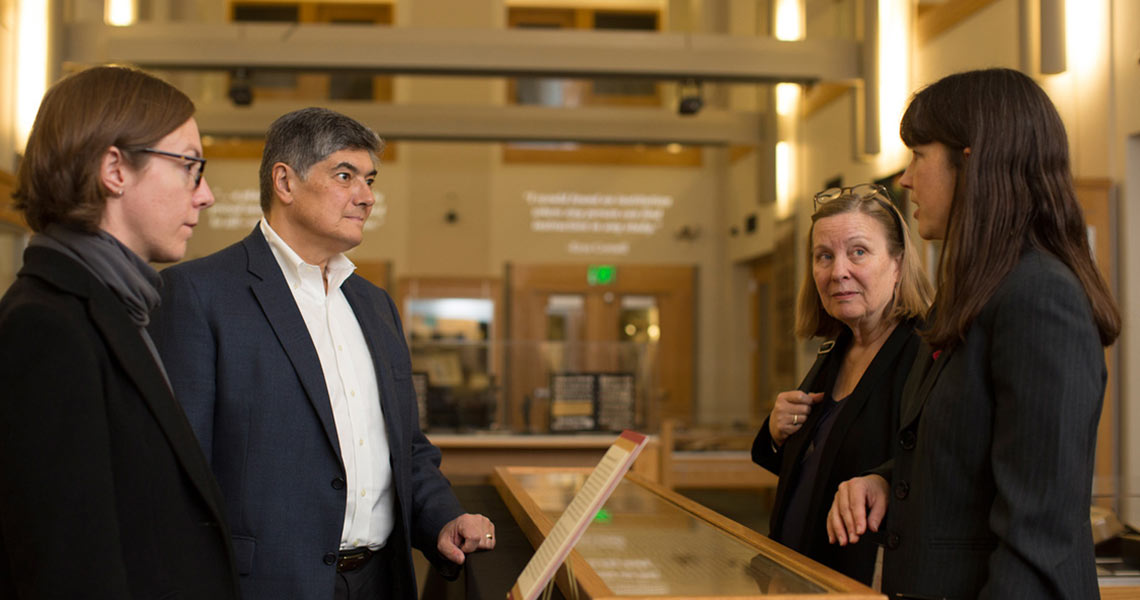 Christopher G. Oechsli, president and CEO of Atlantic Philanthropies (second from left), visits Cornell Library's Rare and Manuscript Collections.